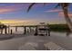 Dock with a boat and waterfront views, perfect for fishing or enjoying a sunset cruise on the water at 4 Winslow Pl, Longboat Key, FL 34228