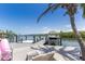 Dock overlooking calm water and clear blue skies with lounge chairs and an inflatable at 4 Winslow Pl, Longboat Key, FL 34228