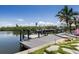 Waterfront dock features boat lift, providing convenient access for boating and enjoying the scenic water views at 4 Winslow Pl, Longboat Key, FL 34228