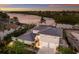 Beautiful waterfront home with a three-car garage, meticulously landscaped grounds, and stunning river views at sunset at 4 Winslow Pl, Longboat Key, FL 34228