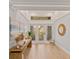 Bright and inviting foyer with wood floors, stylish console table, decorative mirror, and natural light streaming in at 4 Winslow Pl, Longboat Key, FL 34228