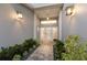 Elegant entrance featuring a stone pathway, lush green landscaping, and modern lighting fixtures, creating a warm ambiance at 4 Winslow Pl, Longboat Key, FL 34228