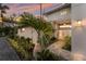 Charming home entrance with stone pathway, manicured landscaping, and double doors providing an inviting welcome at 4 Winslow Pl, Longboat Key, FL 34228