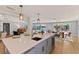 Open concept kitchen with island seating, quartz countertops, stainless steel appliances, and waterway views at 4 Winslow Pl, Longboat Key, FL 34228