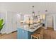 Spacious kitchen with quartz countertops, stainless steel appliances, island, and modern fixtures at 4 Winslow Pl, Longboat Key, FL 34228