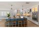 Bright kitchen with island seating, pendant lighting, stainless steel appliances and lots of storage at 4 Winslow Pl, Longboat Key, FL 34228