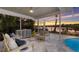 Relaxing screened lanai with water view, stylish seating, and access to the pool at 4 Winslow Pl, Longboat Key, FL 34228