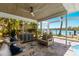 Inviting outdoor living space with comfortable seating, beautiful water views and pool access at 4 Winslow Pl, Longboat Key, FL 34228