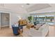 Living room with a view of the pool and waterway with comfortable seating and neutral decor at 4 Winslow Pl, Longboat Key, FL 34228