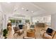 Bright, open living room featuring wood floors, recessed lighting and a view of the pool at 4 Winslow Pl, Longboat Key, FL 34228