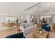 Open-concept living room with wood floors and comfortable seating near the kitchen and dining area at 4 Winslow Pl, Longboat Key, FL 34228