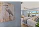 Bedroom with blue walls, king bed, neutral decor, and a sliding glass door with water views at 4 Winslow Pl, Longboat Key, FL 34228