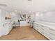 Spacious office with custom white cabinets, shelving, and desks, bathed in natural light at 4 Winslow Pl, Longboat Key, FL 34228