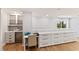 Office features custom white cabinets, desk space, and a view to the outdoors at 4 Winslow Pl, Longboat Key, FL 34228