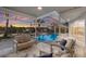 Covered lanai with an inviting pool, scenic waterfront views, and comfortable lounging space at 4 Winslow Pl, Longboat Key, FL 34228