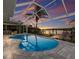 Gorgeous outdoor pool with a covered lanai, waterfront views, and a private dock, perfect for relaxing and entertaining at 4 Winslow Pl, Longboat Key, FL 34228