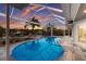 Sparkling pool with screened enclosure and waterfront views, perfect for relaxation and entertaining at 4 Winslow Pl, Longboat Key, FL 34228
