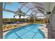 Beautiful screened pool with a dock and boat, perfect for waterfront living and enjoying sunny days at 4 Winslow Pl, Longboat Key, FL 34228