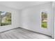 Bright bedroom features updated flooring and abundant natural light from the windows at 4131 Oakhurst W Cir # 3133, Sarasota, FL 34233