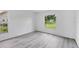 Bright bedroom features updated flooring and abundant natural light from the windows at 4131 Oakhurst W Cir # 3133, Sarasota, FL 34233