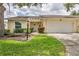 Charming single-story home with a well-manicured lawn and attached two-car garage at 4131 Oakhurst W Cir # 3133, Sarasota, FL 34233