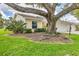 View of home with a mature tree in the front yard at 4131 Oakhurst W Cir # 3133, Sarasota, FL 34233