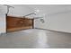 Spacious garage with an epoxy floor and a garage door leading to additional storage space at 4131 Oakhurst W Cir # 3133, Sarasota, FL 34233