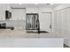 Modern kitchen featuring stainless steel appliances, white cabinets, and a large island at 4131 Oakhurst W Cir # 3133, Sarasota, FL 34233