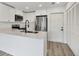 Modern kitchen featuring stainless steel appliances, white cabinets, and a large island at 4131 Oakhurst W Cir # 3133, Sarasota, FL 34233