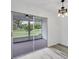 Living Room with sliding glass doors to the screened lanai and new hardwood style flooring at 4131 Oakhurst W Cir # 3133, Sarasota, FL 34233