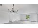 Bright living room with modern chandelier, new floors, and neutral decor at 4131 Oakhurst W Cir # 3133, Sarasota, FL 34233