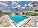 Community pool with a screened enclosure and deck chairs perfect for relaxation at 4131 Oakhurst W Cir # 3133, Sarasota, FL 34233