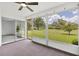 Relaxing sunroom featuring large windows providing views of the lush outdoors and access to additional rooms at 4131 Oakhurst W Cir # 3133, Sarasota, FL 34233