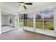 Relaxing sunroom featuring large windows providing views of the lush outdoors and a ceiling fan at 4131 Oakhurst W Cir # 3133, Sarasota, FL 34233