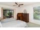 Bright bedroom featuring twin beds, ceiling fan, and large windows offering ample natural light at 4165 66Th Street W Cir # H, Bradenton, FL 34209