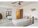 Bedroom with twin beds, a closet with mirrored doors and view of an ensuite bath at 4165 66Th Street W Cir # H, Bradenton, FL 34209