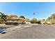 Well-maintained building exterior with manicured landscaping, parking and an American flag at 4165 66Th Street W Cir # H, Bradenton, FL 34209