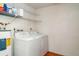 Laundry room with a washer, dryer, and storage shelving for organization at 4165 66Th Street W Cir # H, Bradenton, FL 34209