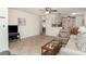 Spacious living room showing tiled floors, a ceiling fan, and an open layout to the kitchen and dining areas at 4165 66Th Street W Cir # H, Bradenton, FL 34209