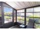 Relaxing screened patio with an outdoor chair and a view of the lawn and trees at 4165 66Th Street W Cir # H, Bradenton, FL 34209