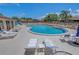 Relaxing community pool area with lounge chairs and tables under a sunny blue sky at 4165 66Th Street W Cir # H, Bradenton, FL 34209