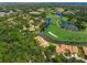 Stunning aerial view of a golf course community featuring mature trees and tile roofs at 4637 Willow Wood Cir # 44, Sarasota, FL 34241