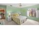 Bright bedroom features a queen-size bed, green walls, and natural light from the window at 4637 Willow Wood Cir # 44, Sarasota, FL 34241