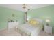 Bedroom showcases light green walls, a ceiling fan, and white wicker furniture, plus natural light at 4637 Willow Wood Cir # 44, Sarasota, FL 34241