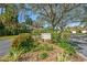 Welcome to Hammocks IV sign surrounded by beautiful plants and shrubs at 4637 Willow Wood Cir # 44, Sarasota, FL 34241