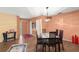 Dining area with wood floors, seating for six, and natural light near the front door at 4637 Willow Wood Cir # 44, Sarasota, FL 34241