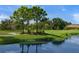 Pictureque golf course pond with mature trees at 4637 Willow Wood Cir # 44, Sarasota, FL 34241