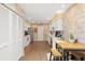 Well-lit kitchen featuring white cabinets and ample counter space with an adjacent dining area at 4637 Willow Wood Cir # 44, Sarasota, FL 34241