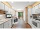 Bright kitchen with wood floors, white cabinets, modern appliances and a breakfast nook at 4637 Willow Wood Cir # 44, Sarasota, FL 34241