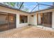 Screened in brick lanai provides access to the home's various interior spaces at 4637 Willow Wood Cir # 44, Sarasota, FL 34241
